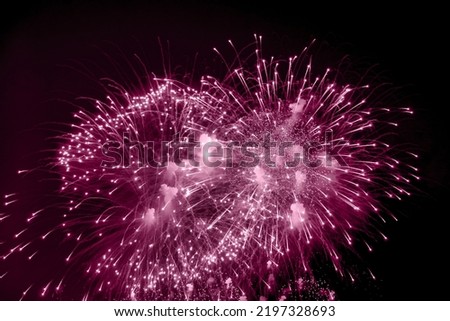 Pink holiday fireworks background with sparks, colored stars and bright nebula on black night sky universe. Amazing beauty colorful fireworks display on celebration, showing. Holidays backgrounds