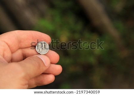 Antique Greek coin in hand