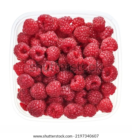 Plastic container with raspberry. Top view of raw fruits isolated on white background. Preparing vegetables for freezing. Storage for winter storage in trays