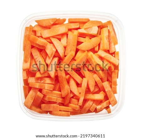 Chopped carrots in plastic container. Top view of raw vegetables isolated on white background. Preparing vegetables for freezing. Storage for winter storage in trays