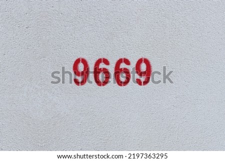 Red Number 9669 on the white wall. Spray paint.
