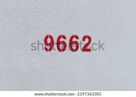 Red Number 9662 on the white wall. Spray paint.
