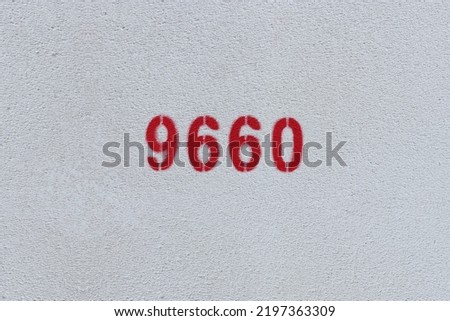 Red Number 9660 on the white wall. Spray paint.
