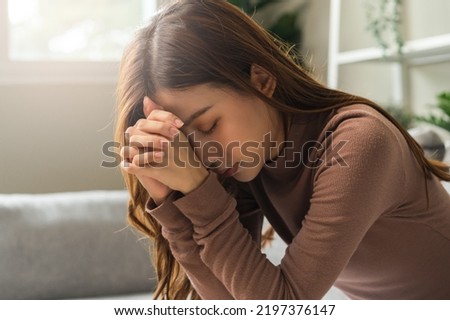 Believe faith charity, calm asian young woman show gratitude, folded hands in prayer feel grateful, meditating with her eyes closed, praying to request God for help. Religious, forgiveness concept. Royalty-Free Stock Photo #2197376147