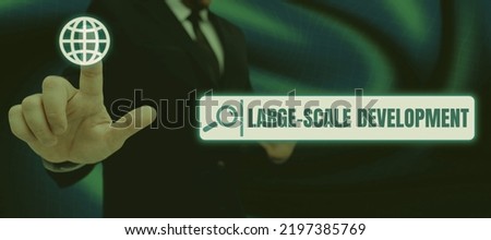 Text sign showing Large Scale Development. Business idea Develop on an extensive basis grow up a lot Woman Typing Recent Update On Lap Top And Holding Important Ideas Over Hand