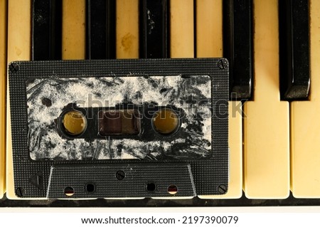 Photo picture close-up of piano keys keyboard and musicassette tape