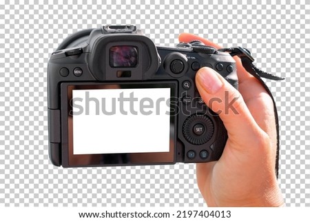 Modern digital mirrorless camera mockup. Photographer holding camera in hand, transparent background pattern.