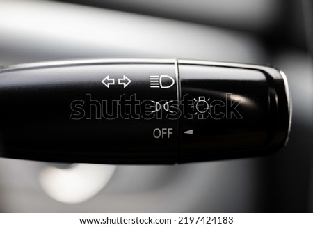 Turn signal lever, adjusting car headlight control switch.