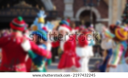 Blurred images of mascots parade show. Capture images of mascot characters model dancing with theme park song. Show for fan at  Christmas festive in Tokyo. Blurry for background images.
