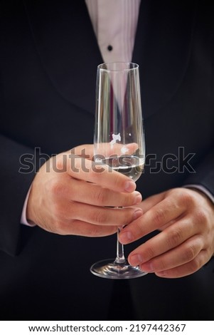 Men's hands with a glass of expensive champagne