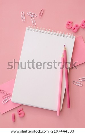 School supplies accessories stationery on pink background, flat lay, top view. Education supply accessory open empty notebook stuff. Back to school concept. Flatlay from above. Vertical copy space. Royalty-Free Stock Photo #2197444533