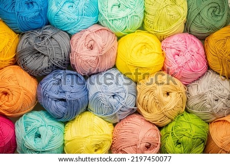 Background from colored yarn. Balls of thread close-up. Materials for needlework. Rack with yarn in the store. Shelf with multi-colored threads for knitting. Royalty-Free Stock Photo #2197450077