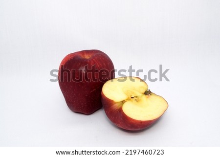 Red apple and red apple cut in a half photo on a white background