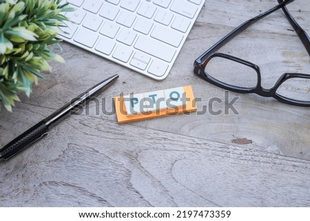The word PTO on the orang post-it note. Paid Time Off concept Royalty-Free Stock Photo #2197473359