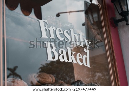 Bakery with "Freshly baked" lettering at the storefront display.