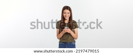 Laughing woman talking and texting on the phone isolated on a white background. Royalty-Free Stock Photo #2197479015