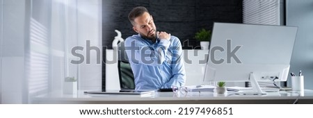 Posture Fatigue Shoulder Pain. Mature Man At Computer Workstation Royalty-Free Stock Photo #2197496851