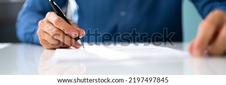 Agreement Signature With Pen. Hand Signing Paper Form Royalty-Free Stock Photo #2197497845