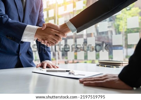 shake hand Real estate brokerage agent Deliver a sample of a model house to the customer, mortgage loan agreement Making lease and buy and sell house And contract home insurance mortgage loan concept Royalty-Free Stock Photo #2197519795