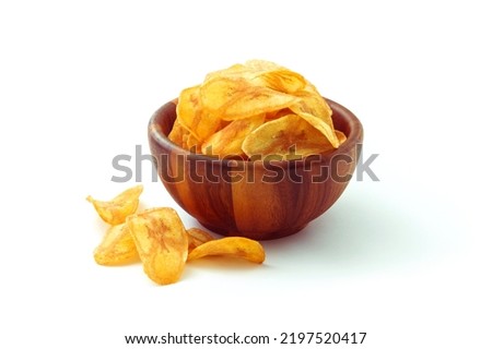 Banana slice chips in wooden bowl isolated on white background. Royalty-Free Stock Photo #2197520417