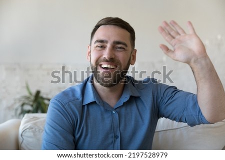 Head shot portrait handsome bearded millennial man make video call, greeting family or friend staring at camera feels happy. Virtual meeting event at home, modern tech, remote communication concept Royalty-Free Stock Photo #2197528979