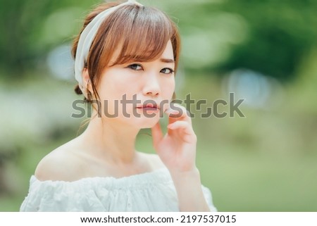 A woman in the green (worried,  doubted) Royalty-Free Stock Photo #2197537015