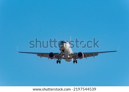 Passenger airplane on approach to the airport landing - stock photo