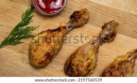 Fried chicken drumstick on a wooden background. Background picture.