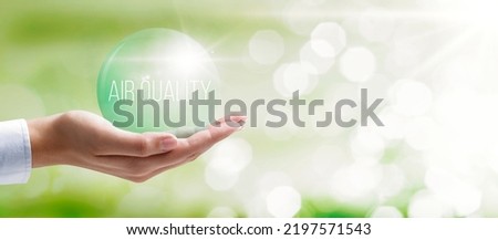 Hand holding a bubble of clean air: air quality index monitoring Royalty-Free Stock Photo #2197571543