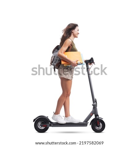 Smiling student with backpack riding an eco-friendly electric scooter, isolated on white background Royalty-Free Stock Photo #2197582069