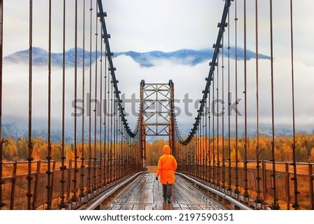 one person on the bridge from the back view, travel adventure, suspension bridge