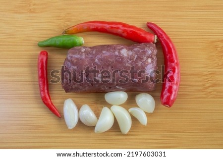 Thai food Fermented beef with  red chili peppers, garlic on old wooden plate Royalty-Free Stock Photo #2197603031