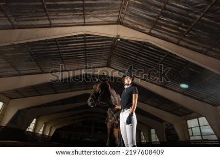 Equestrian sport - a young girl with her horse. Royalty-Free Stock Photo #2197608409