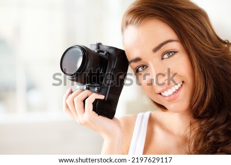 Portrait of happy woman photographer working in model studio doing photoshoot with camera. Career, creative and photography student doing media project. Lady with startup art production business.