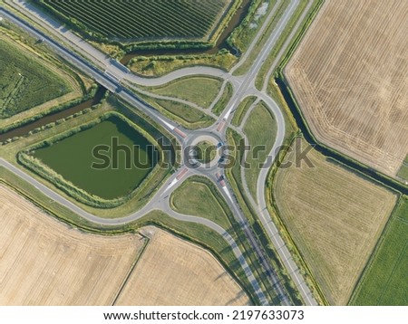 Roundabout junction aerial vehicle auto motorway intersection. Transportation safety crossroad. Circular ring road infrastructure street. Aerial drone overview.