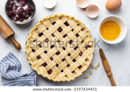 Raw homemade  cherry pie with baking ingredients. Making pie series. Step by step recipe. Top view Royalty-Free Stock Photo #2197634451