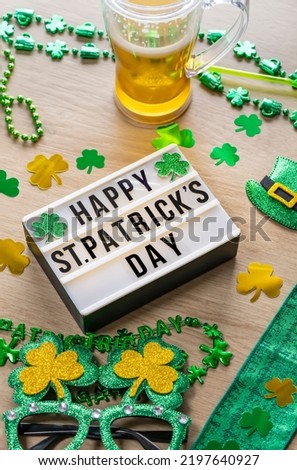 Happy st Patrick's day lightbox message with green decorations,gift with ribbon, green leaves of clover, trefoil.