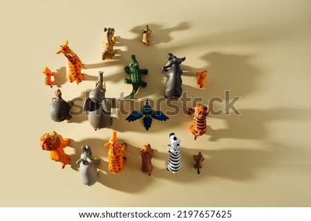 Toy animals with shadows on beige background. Toys for Kids.  Games for learning and development of the child.