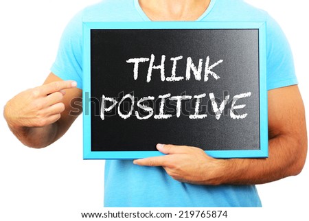 Man holding blackboard in hands and pointing the word THINK POSITIVE
