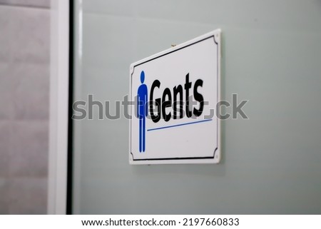 male toilet signs on the door, bokeh, blurred background in the toilet, blue sign 