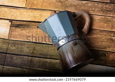 Mocha port coffee maker on wooden floor high resolution photography