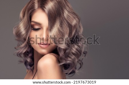 Beautiful model girl with short hair .Beauty woman with blonde curly hairstyle dye .Fashion, cosmetics and makeup. Fashionable coloring in gray