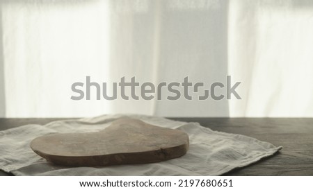 Empty olive wood board on wood table, wide photo