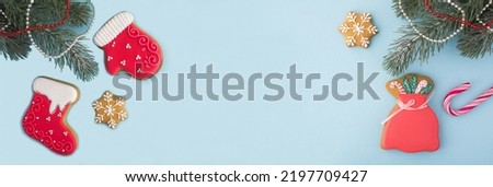Christmas banner with gingerbread on the blue background.Top view. Copy space.