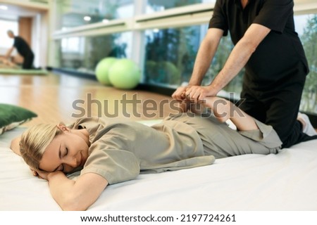 Yumeiho therapy. Massage therapist doing massage using oriental techniques Yumeiho for correcting posture of woman's body Royalty-Free Stock Photo #2197724261