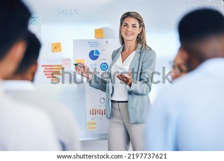 Sales, marketing and b2b strategy of business woman speaker giving a presentation to work crowd. Corporate advertising seminar with female present sale analytics and logistics chart on white board Royalty-Free Stock Photo #2197737621