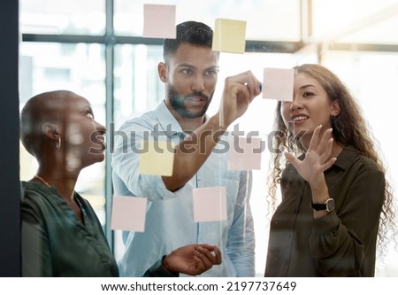 Team strategy meeting on research, post it on glass wall and group work planning together. Business people brainstorming analytics vision think tank ideas, collaboration thinking and sticky notes Royalty-Free Stock Photo #2197737649