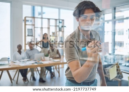 Businessman writing, planning and brainstorming on board in a collaboration meeting. Productive or creative project management people with vision, ideas or mindset for company or business innovation Royalty-Free Stock Photo #2197737749