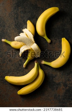 Fresh baby bananas on a dark background