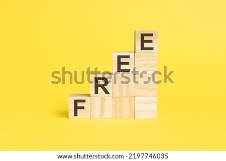 FREE - text on a pyramid of wooden cubes, yellow background